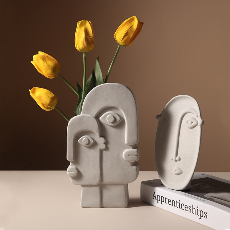 Modern Machine.  Machine Age Modern meets pared down perfection. Our Ceramic Metropolis vases treat edgy cubist-inspired faces to a new stone grey glaze that delicately breaks over the lines.